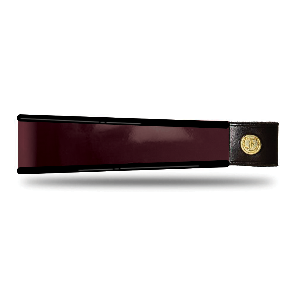 Burgundy and black patent leather browband, wide tapered design, turned edge, polished brass Freedman logo buttons, laid flat.