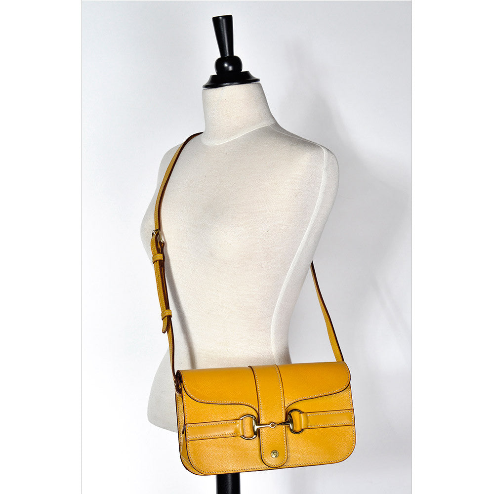 Yellow leather Medium Snaffle Bit Shoulder Bag with snaffle bit hardware, displayed on a mannequin.