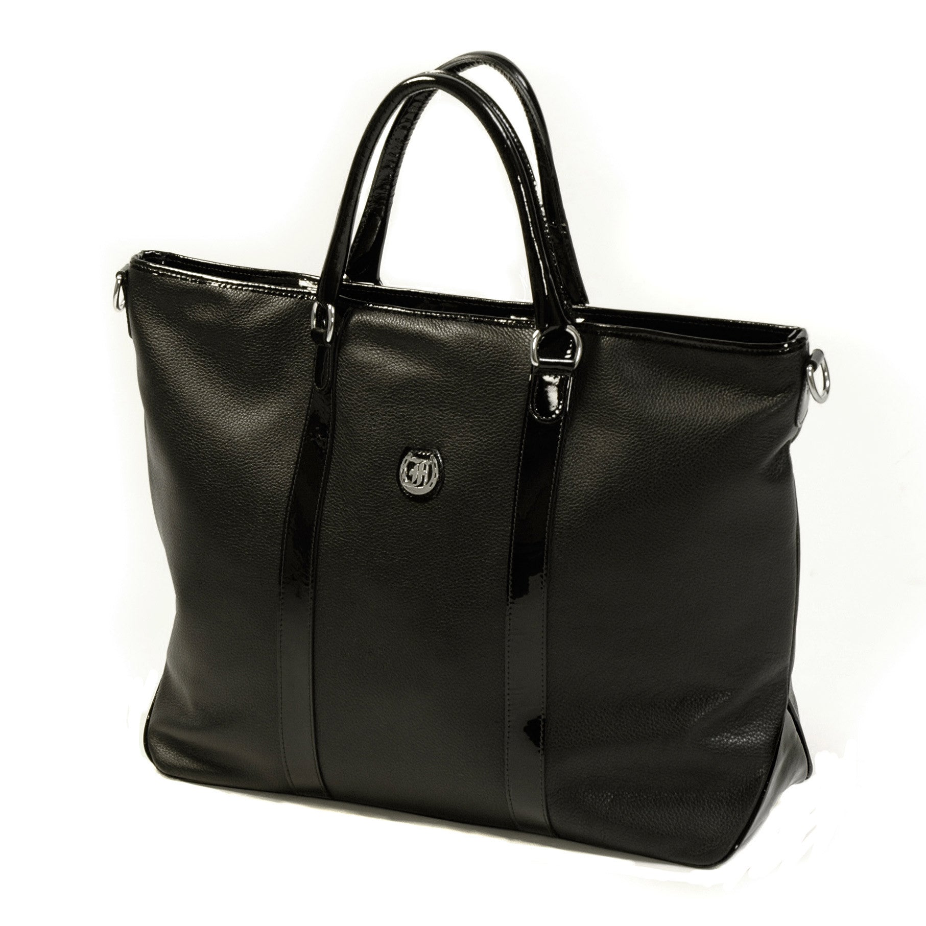 Freedman's Victoria Tote Large, dark textured leather, black leather trim along edges and center straps, embossed circular logo on front, light contrast stitching, dual rolled handles with metal hardware, light background.