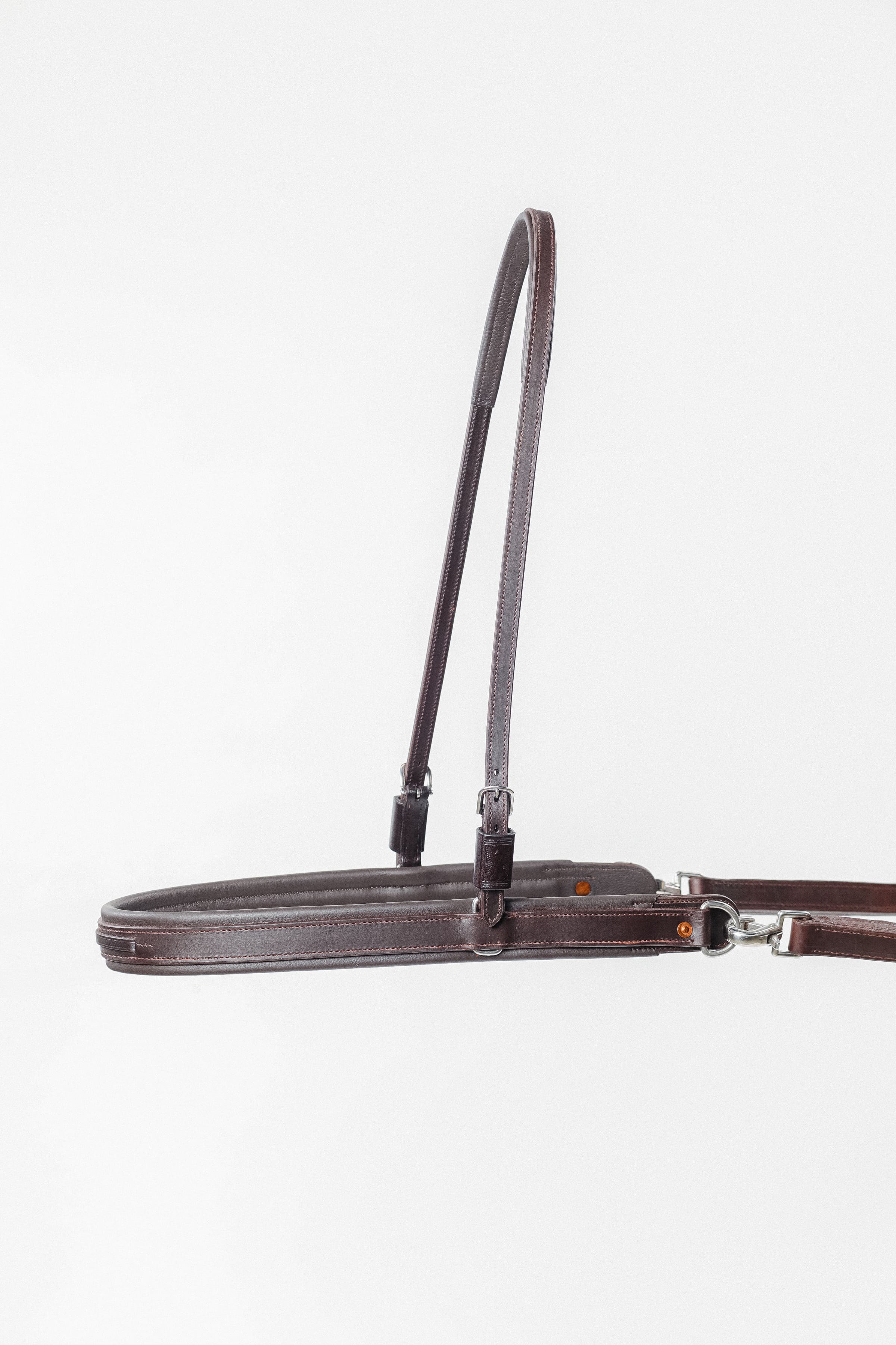 ACTraining Breast Collar and Neck Strap, designed for training or riding, made of brown leather with adjustable buckles and hardware, laid flat on a white background.
