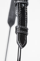  Zoomed-in view of the buckle and strap detail on an Arabian Show Cable Halter. - Side top view.