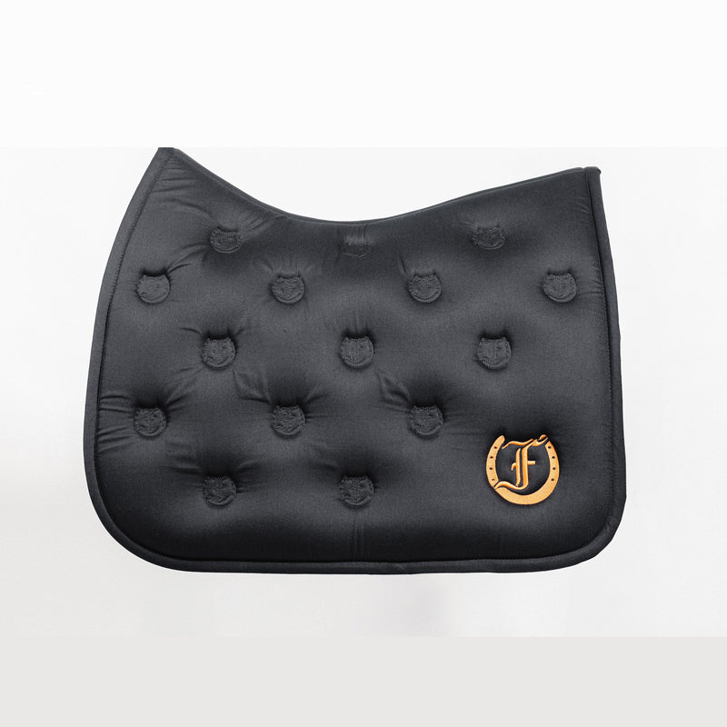 Black quilted saddle pad with a soft and absorbent bamboo lining, featuring an embroidered Freedman's logo, shown on a white background