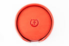 Freedman's Coaster Set in Holder: Red Leather Coasters with Embossed Freedman’s Logo in Center, Close-Up View