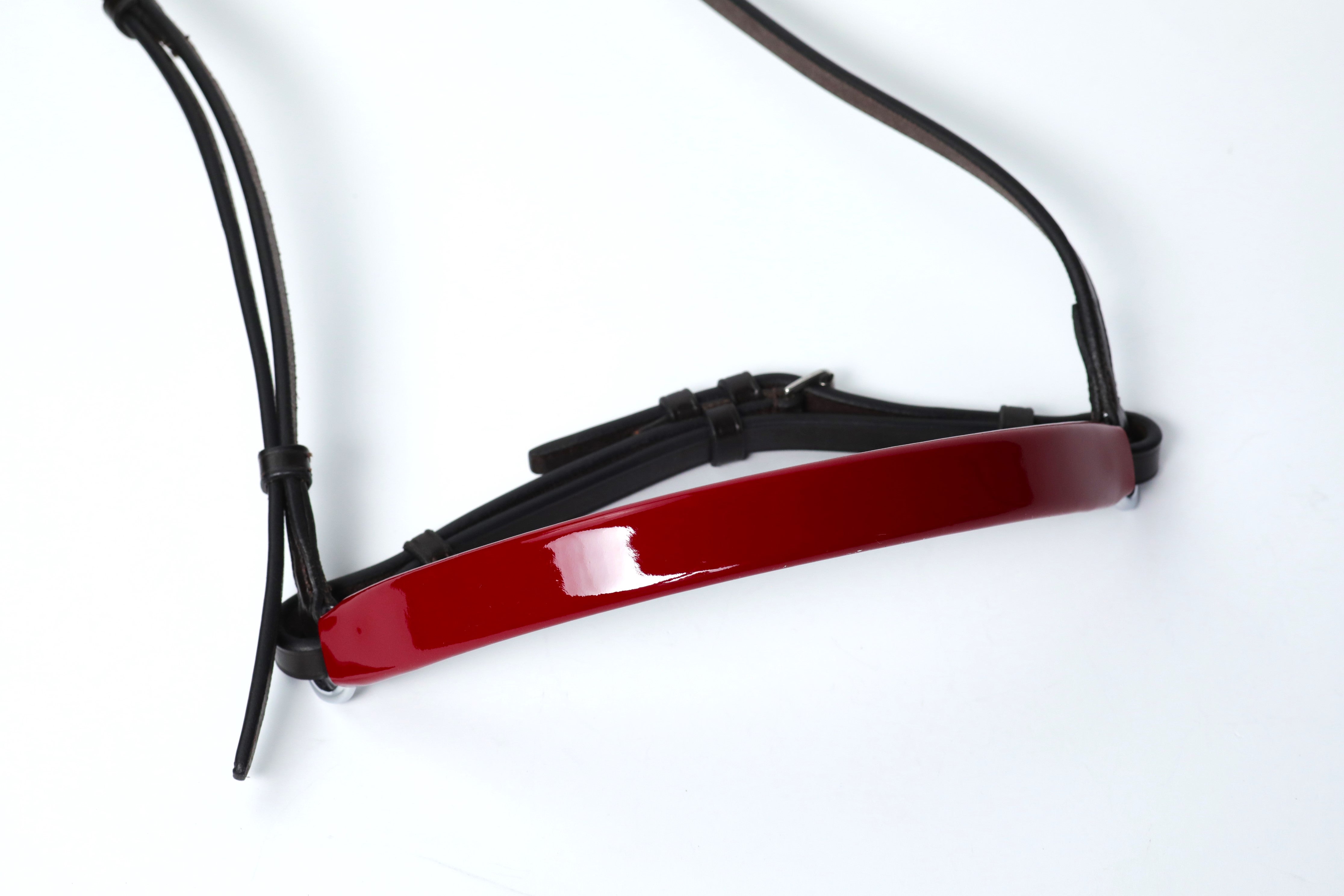 Close-up of Dark Red patent leather Show Cavesons with black leather straps, displayed on a white background.