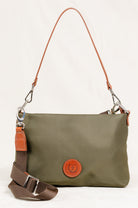  Freedman's Dokar Bag in olive green, close-up shot showing the bag's texture, brown leather accents, detachable shoulder and crossbody straps, and the brand's circular logo patch.