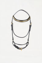 A black leather horse bridle with gold-tone metal hardware and a decorative gold patterned band across the forehead, shown against a plain white background.