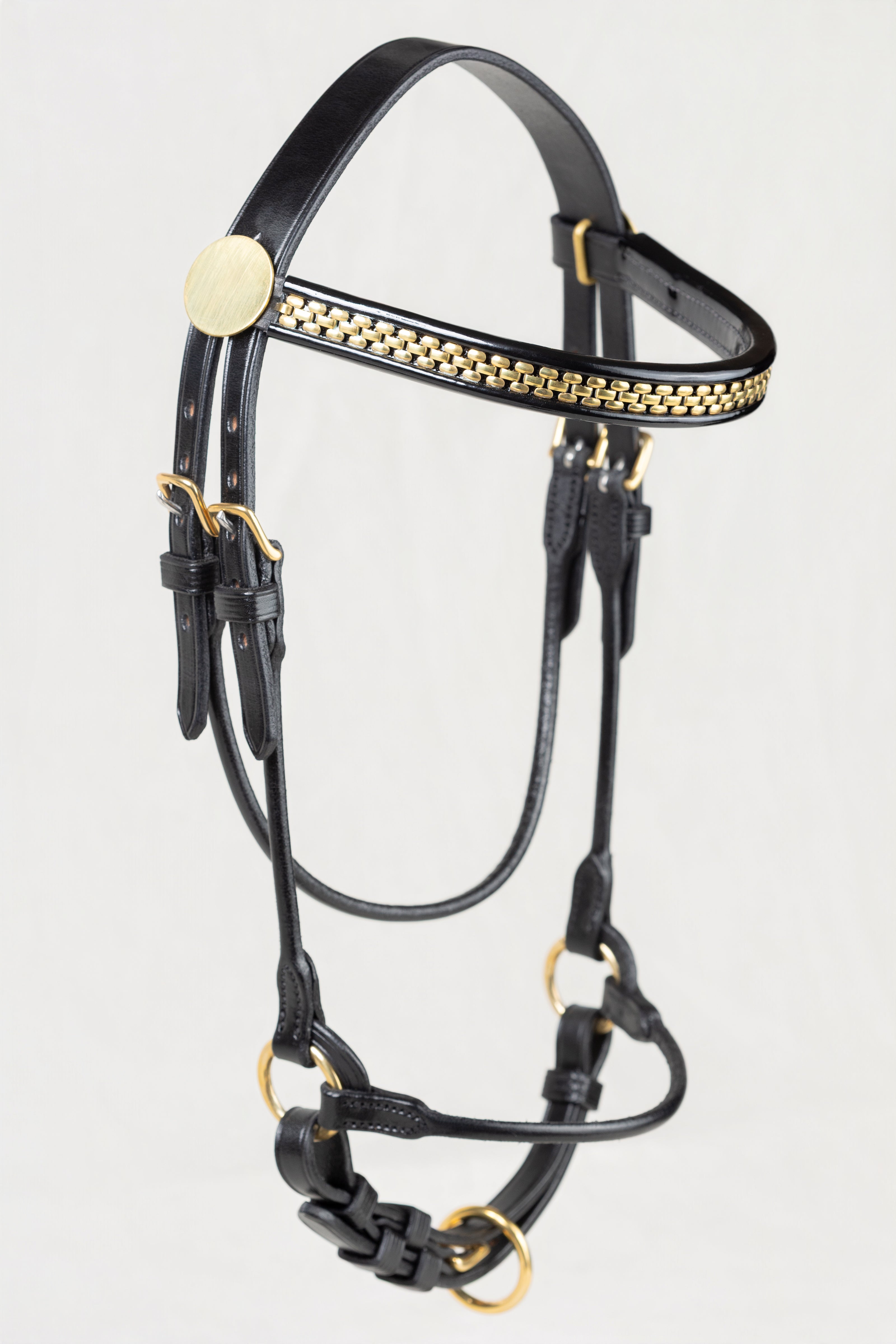 Black leather horse halter with gold-tone hardware and a decorative gold chain pattern on the browband, shown against a plain light gray background.