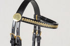 Black leather horse bridle headpiece with gold-tone chain detailing and brass buckles, shown against a light gray background.