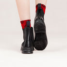 Freedman's Pisgah Jodhpur Boot, black leather, back view with red patterned socks, highlighting the boot's sole and heel details.