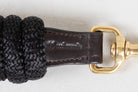 Detailed close-up of the leather on a Freedman Harness black lead rope, showcasing Freedman's logo on a white background
