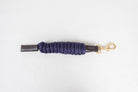 Freedman Harness Navy paracord poly lead rope with premium brown leather accents and a brass snap on a white background.