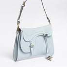 Trooper Shoulder Bag in aquamarine leather by Freedman Harness – sculptural crossbody with saddle-style flap, gold hardware, and adjustable strap