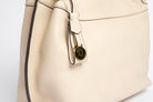 Detail view of Wetherby Tote by Freedman Harness – Putty leather bag with gold logo charm and contrast edge piping