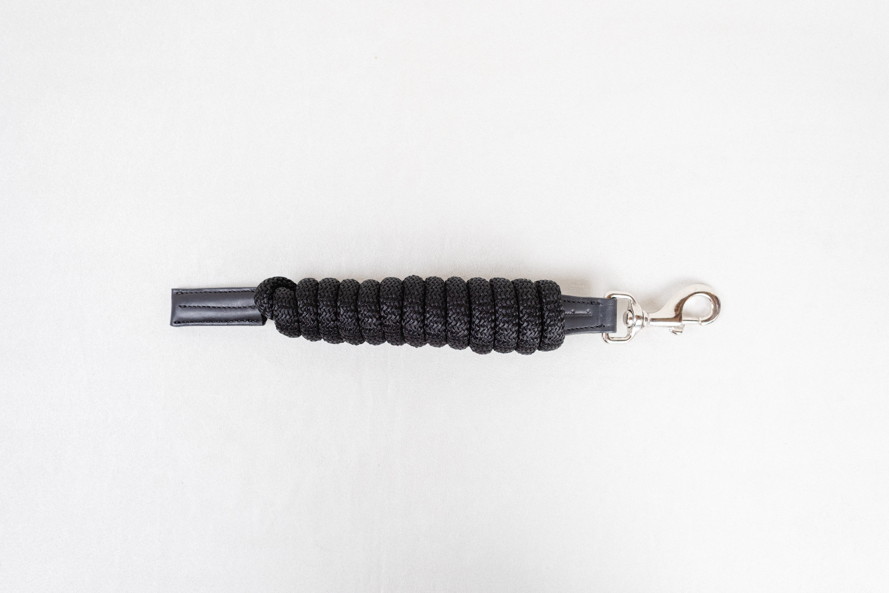 Freedman Harness black paracord poly lead rope with premium black leather accents and a stainless steel snap on a white background.