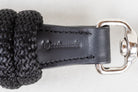 Detailed close-up of the leather on a Freedman Harness black lead rope, showcasing Freedman's logo on a white background
