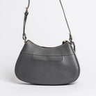 Back view of Carlisle Bag in grey leather by Freedman Harness – curved crossbody handbag with contrast stitching, back slip pocket, and adjustable strap