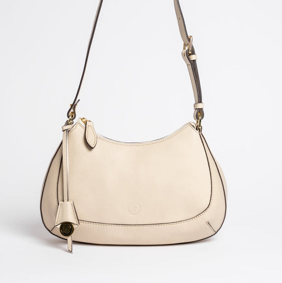 Carlisle Bag in putty leather by Freedman Harness – elegant crossbody handbag with gold hardware, adjustable strap, and minimalist curved silhouette
