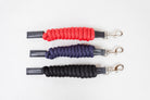 Three Freedman Harness paracord poly and leather snap lead ropes in red, blue, and black, featuring premium stainless steel hardware on a white background.