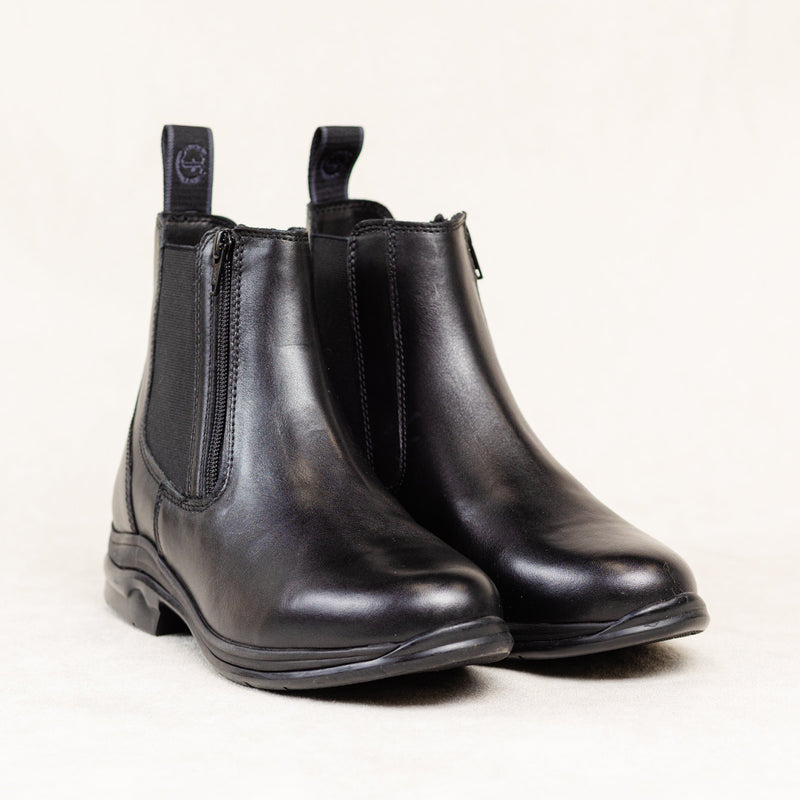 Pair of Pisgah Jodhpur Boots in black leather, featuring a front zipper, elastic side panels, and a low heel, displayed on a light background.