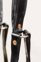 Close-up of Copper Rivet and Silver Metal Ring on Freedman Tail Set complete, Black Leather Detail