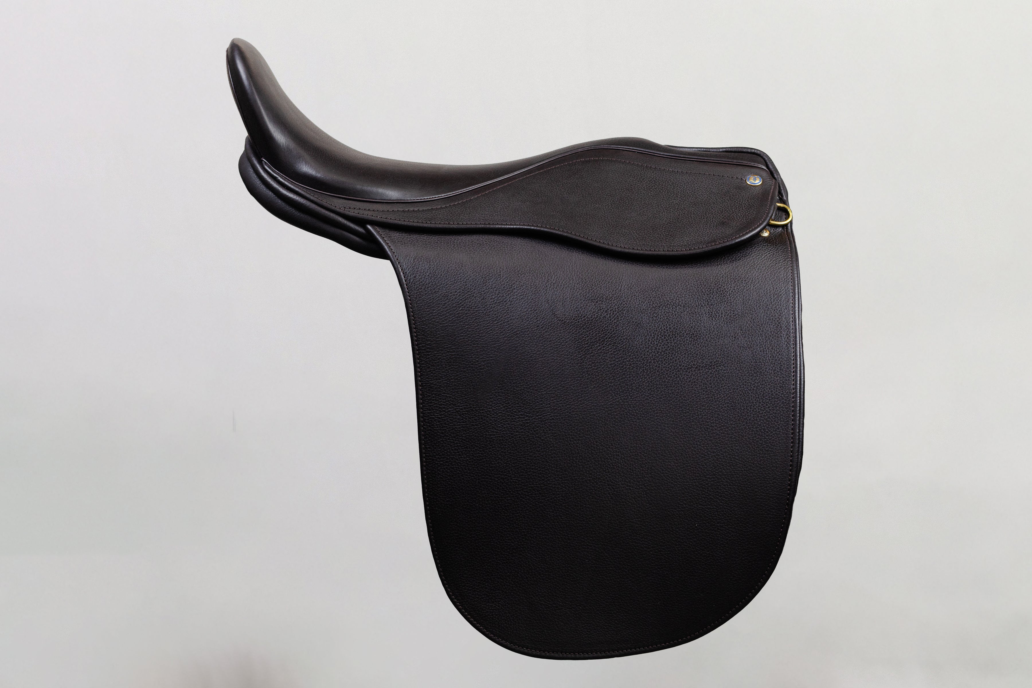 Ultra XD Saddle cutback saddle with a deep seat design for a secure riding experience, shown in side profile in dark leather.