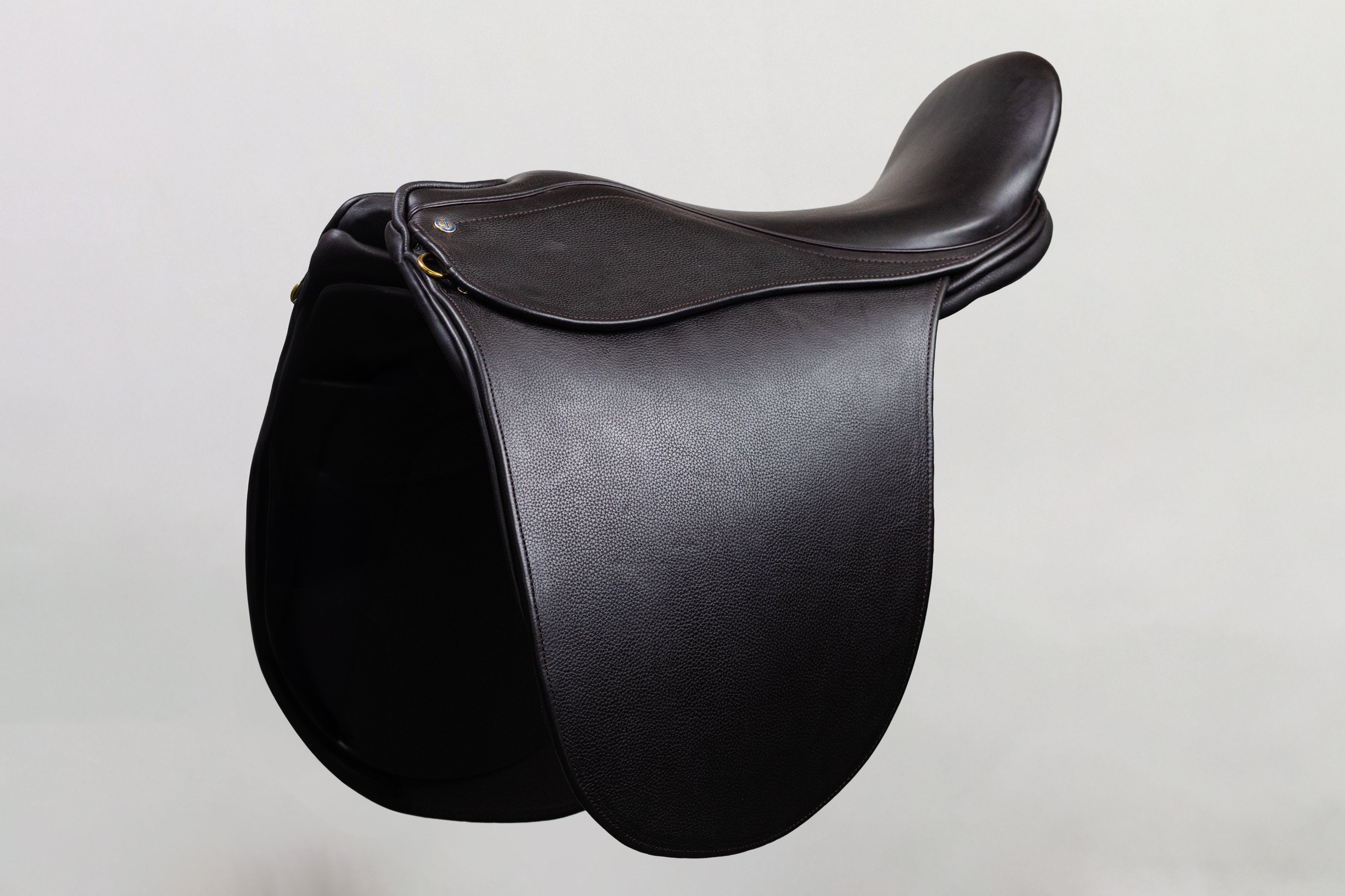 Ultra XD Saddle cutback saddle with a deep seat design for a secure riding experience, shown in side profile in dark leather.