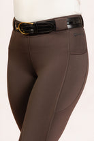 After Dark Brown Jods showing the “Freedman’s” logo with a Patent Scalloped Spur Black Belt on a white background, made by Freedman’s Harness.