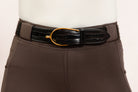 After Dark Brown Jod with the Patent Scalloped Spur Belt featuring a brass buckle on a white background, made by Freedman’s Harness.