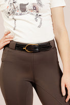 Person wearing a white Signature Ladies' High Stepper T-shirt and After Dark Brown Jods by Freedman’s Harness on a plain background.