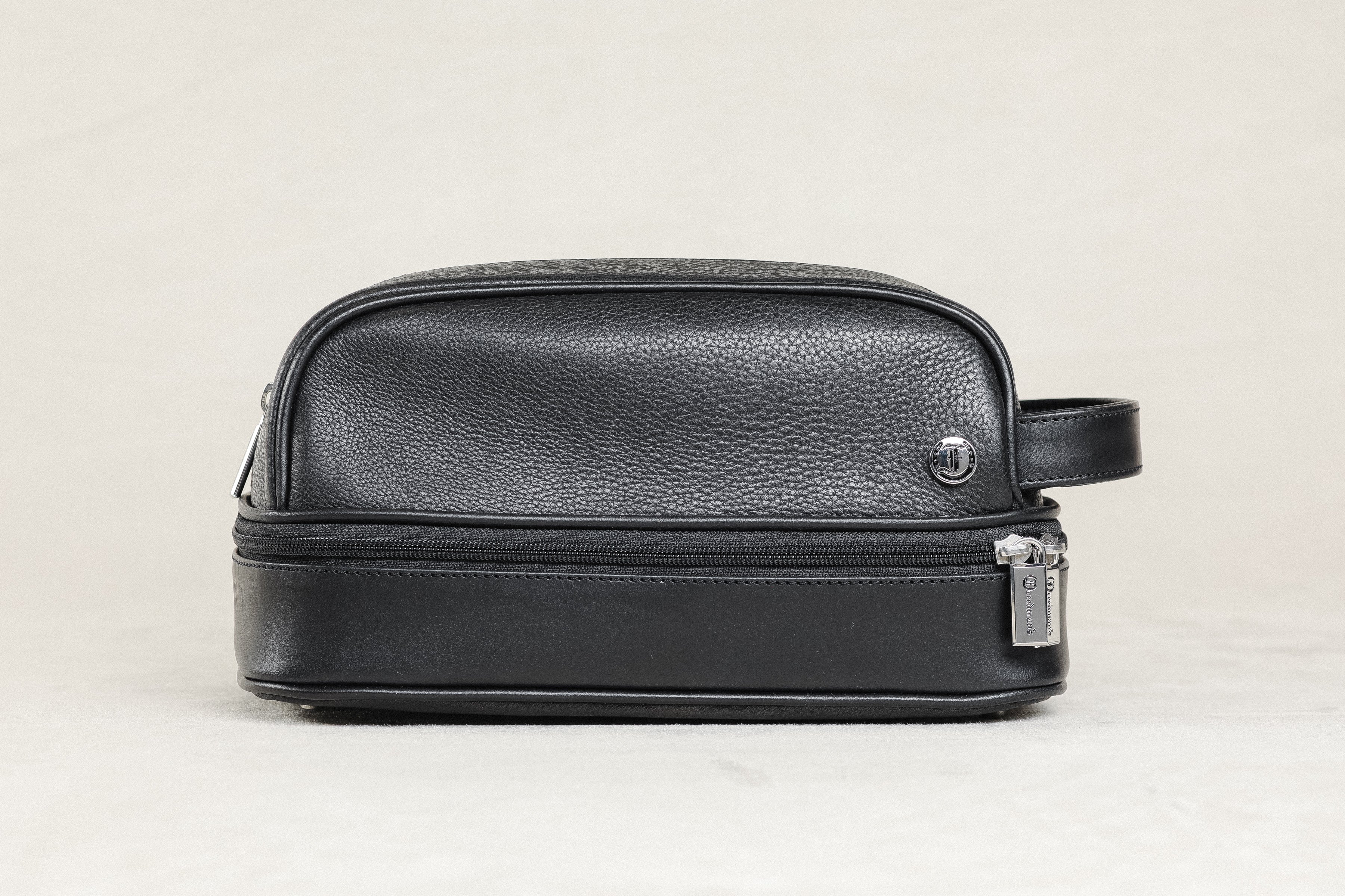 Freedman's Cardiff Shave Bag, black textured leather, dual zippered compartments, silver hardware, side handle, light background.