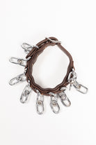 Close-up of ACTraining ankle action chain straps showing leather, buckles, and hanging chains. Image taken from the top