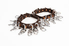 Close-up of ACTraining ankle action chain straps showing leather, buckles, and hanging chains.
