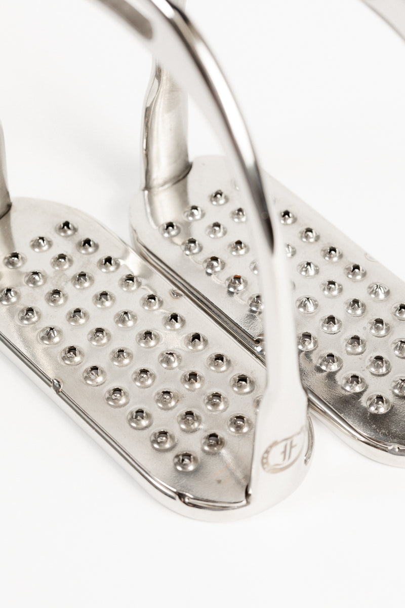 Close-up of Freedman's Logo Hunter Stirrup Irons, showing permanent pick stainless steel treads and brand logo detail.