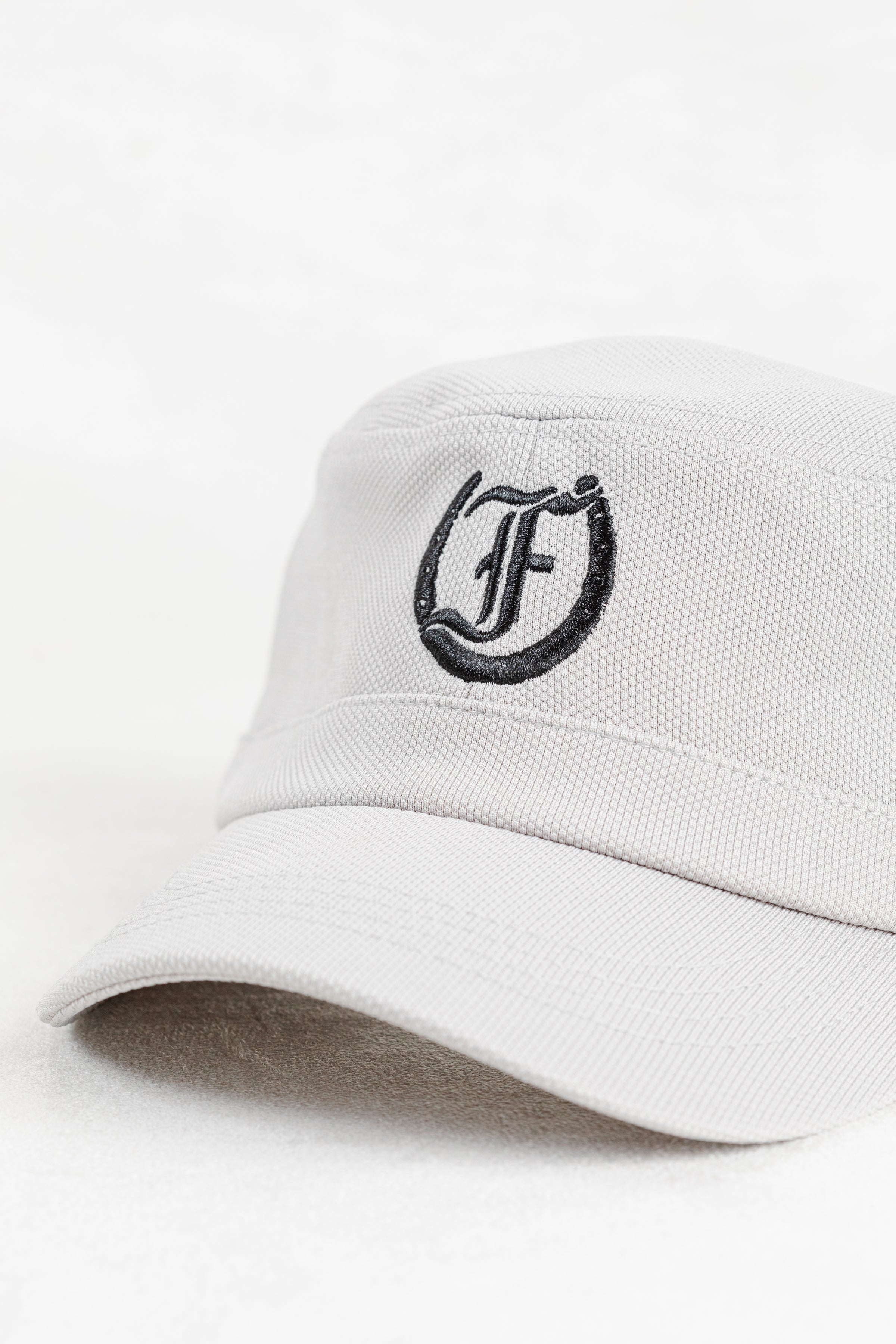 White cap with black Freedman Horseshoe Embroidered logo on a white background