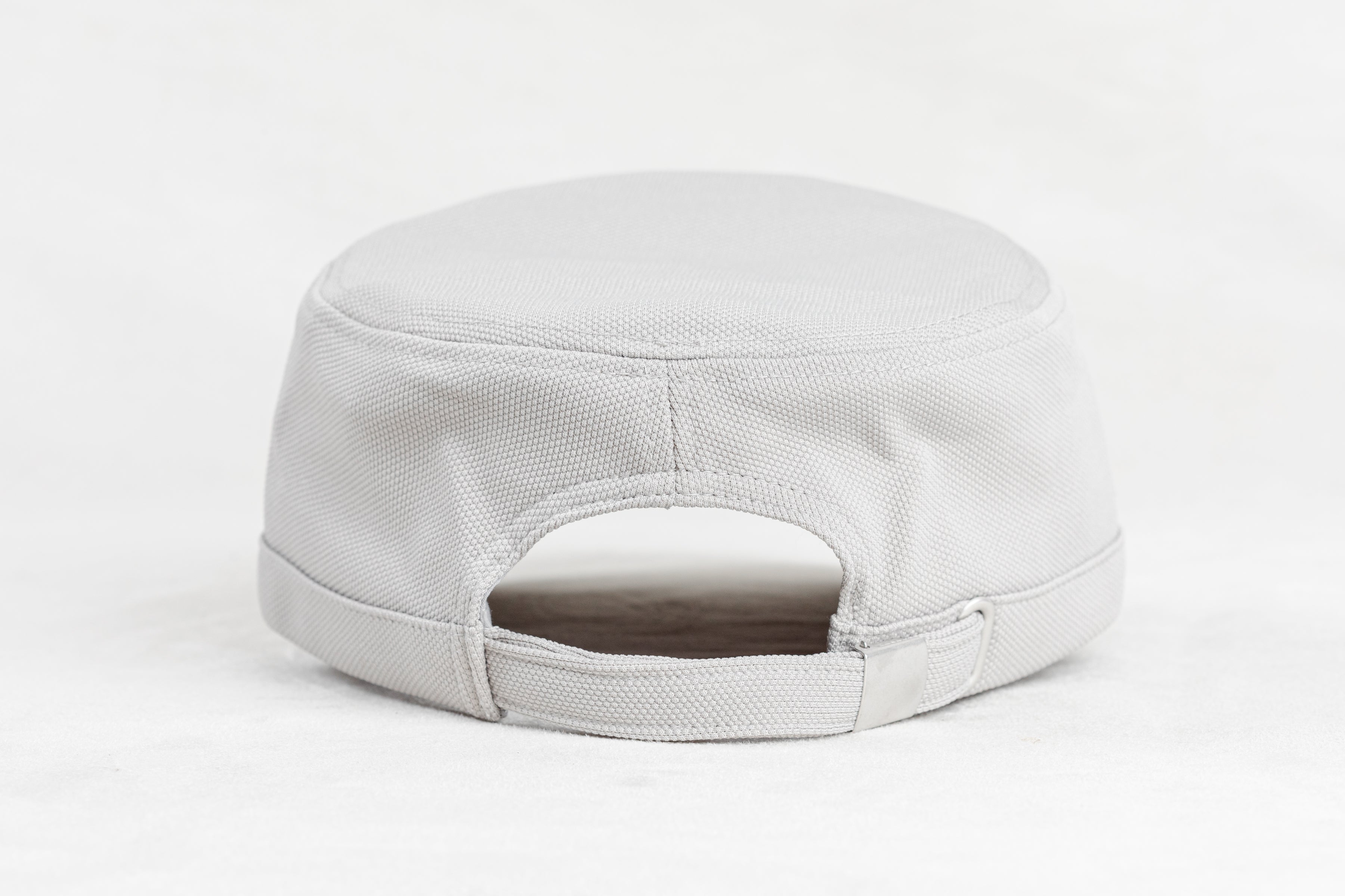 Back of a white cap on a light gray background