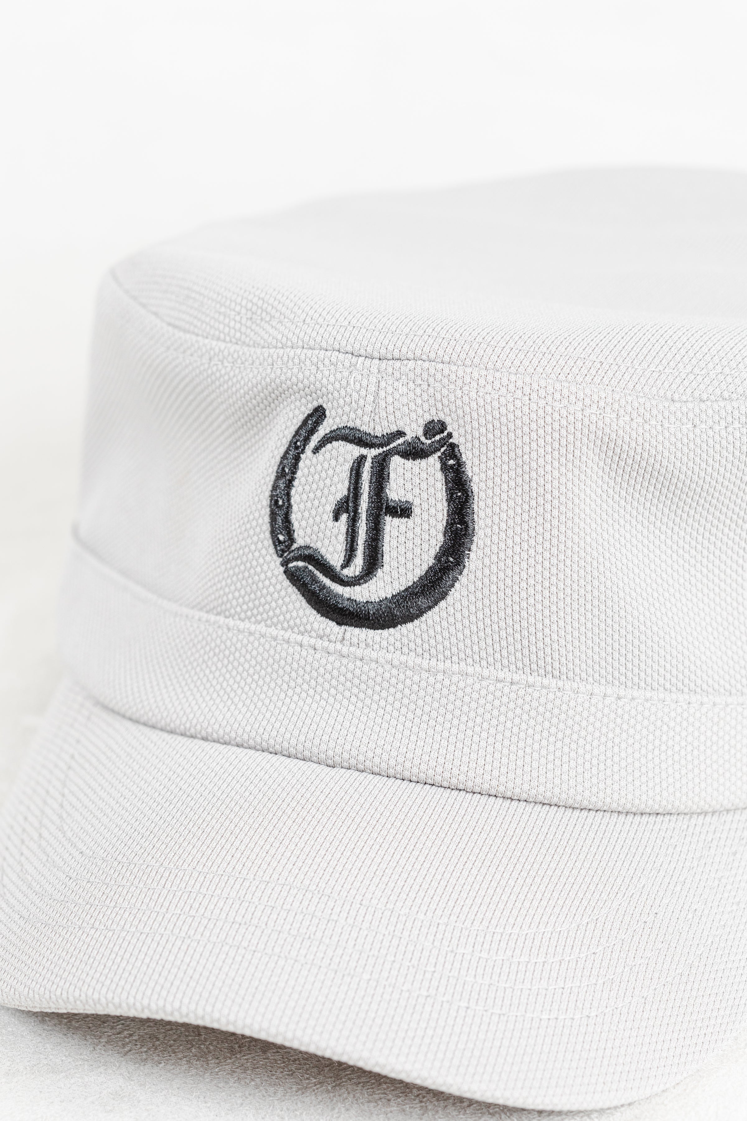 White cap with black Freedman Horseshoe Embroidered logo on a white background
