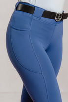 Stiffkey Blue riding Jods with a black belt with freedman logo buckle on a light gray background
