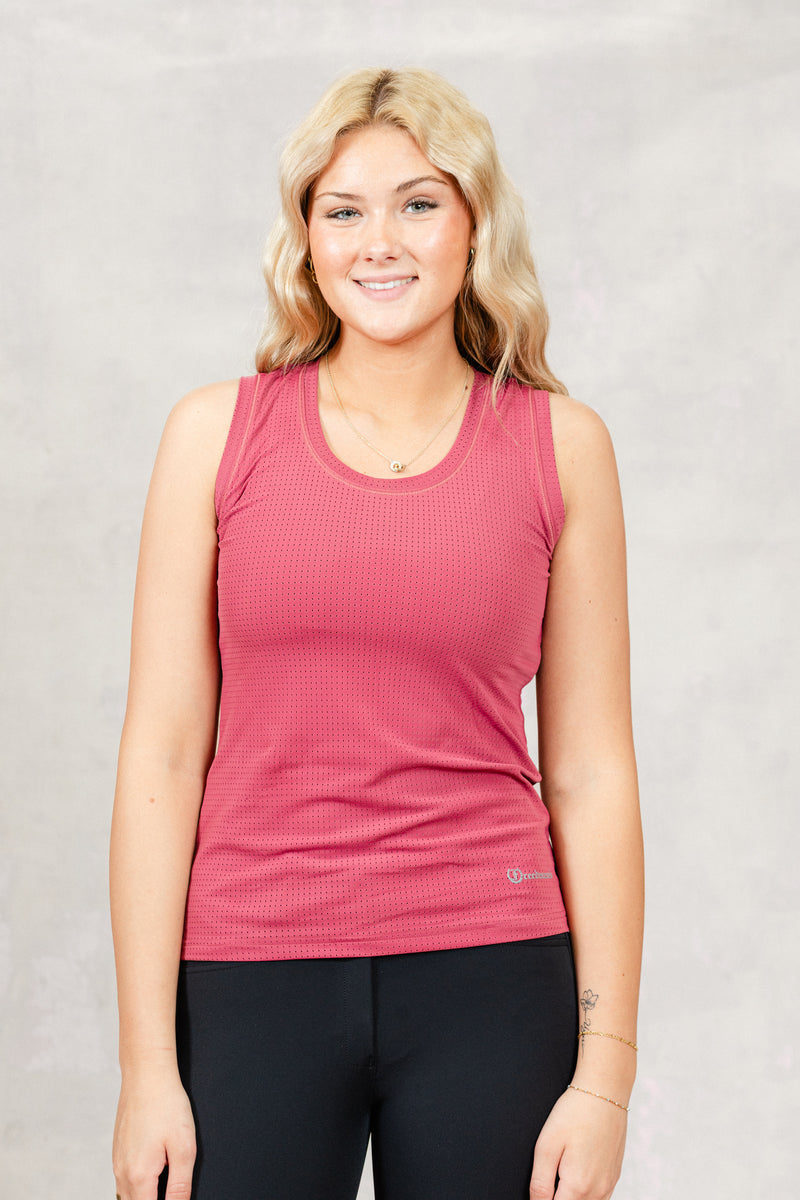 Woman wearing a Freedman's Pink Laser Cut Tank Stop against a plain background