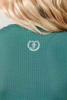Green Laser Tank Top with Freedman's "F" logo on a person wearing it, close-up view.