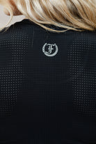 Black Laser Tank Top with Freedman's "F" logo on a person wearing it, close-up view.