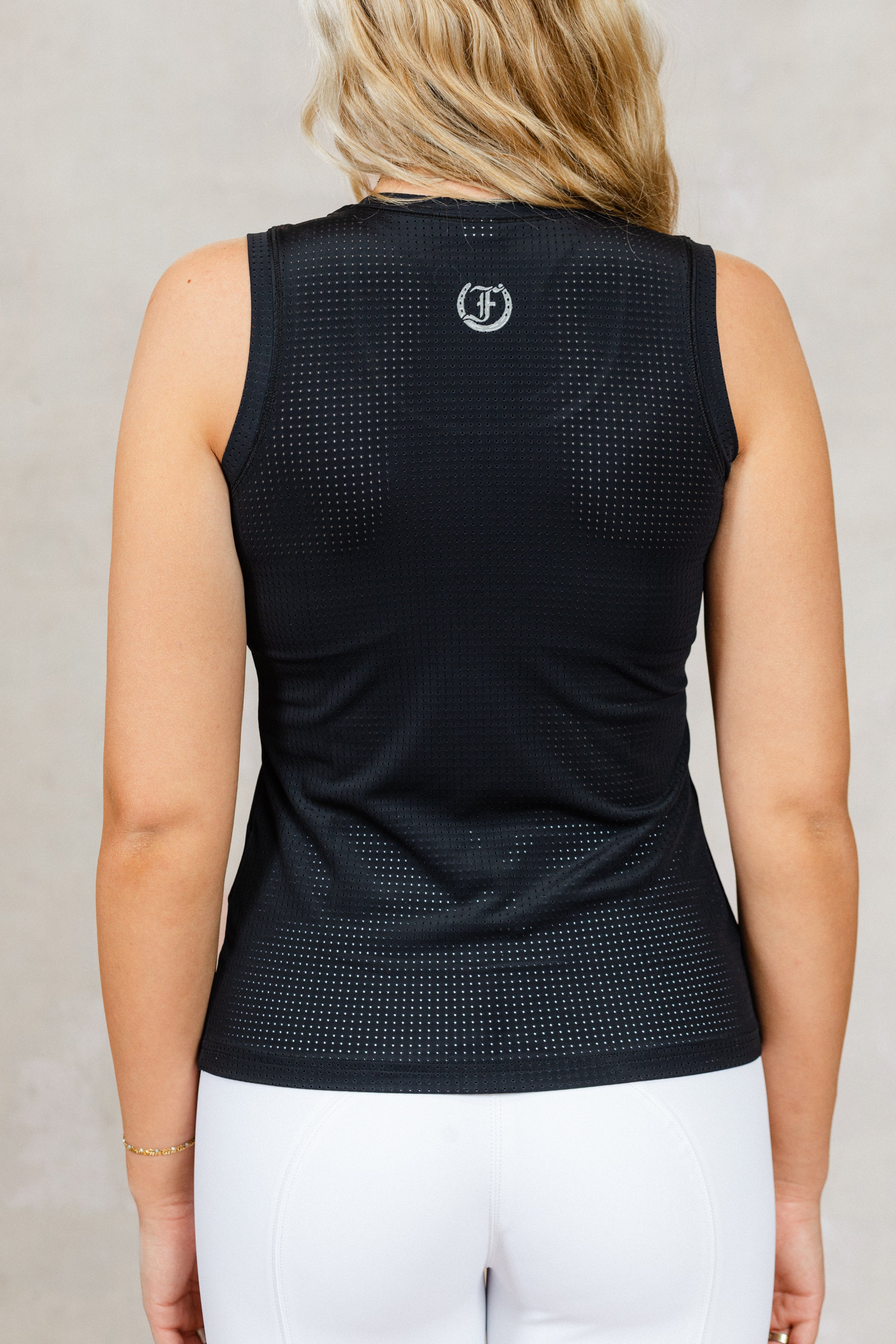 Black Laser tank top with Freedman's "F" logo on the back, worn against a neutral background