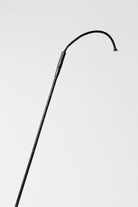 Partial view of a Black Grippy Handle Show Crop with Rhinestone Handle, showing the shaft and part of the grip.