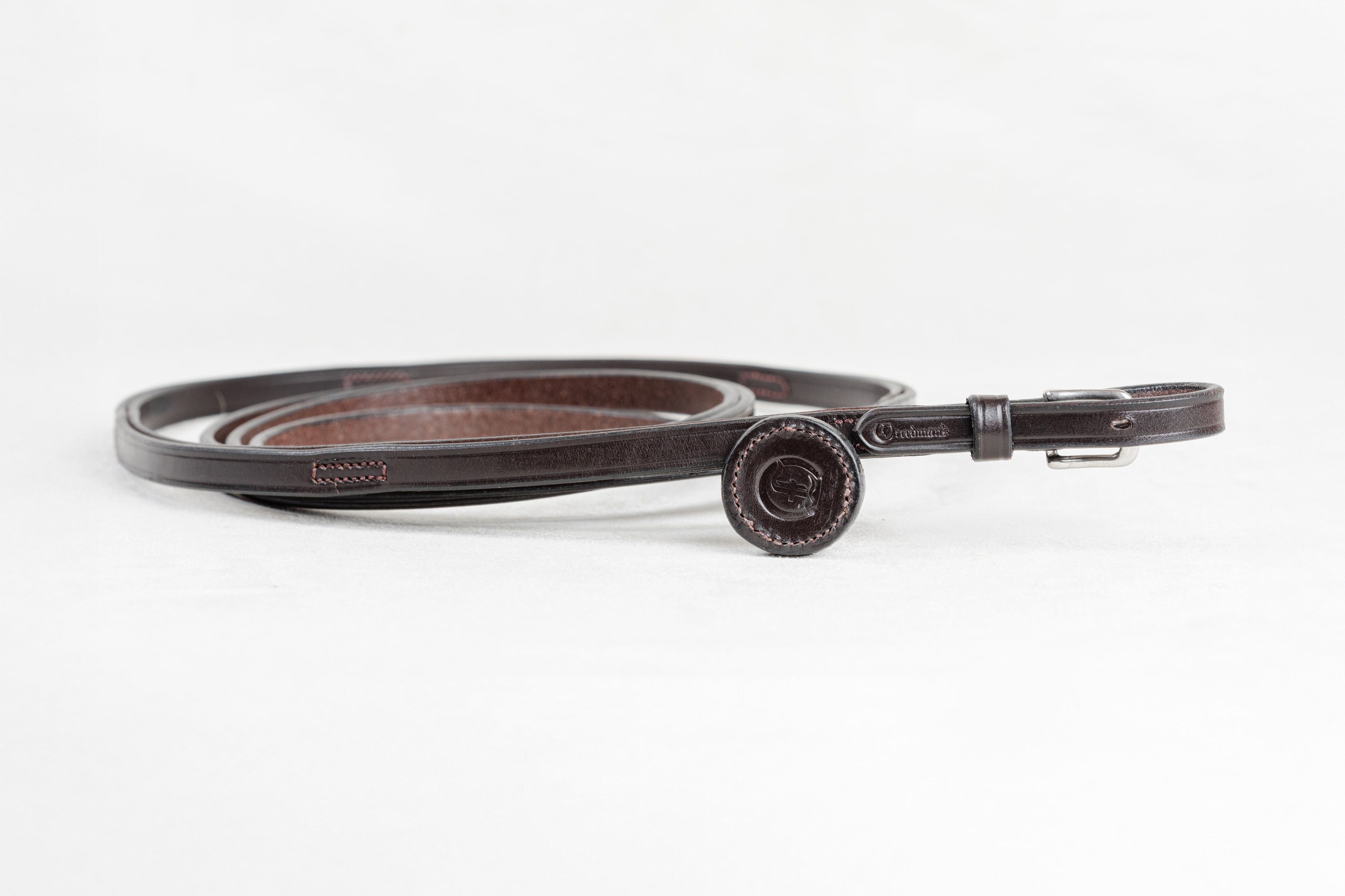 Freedman Harness leather show lead with adjustable handholds, shown in a loose loop with a stainless steel buckle and embossed logo detail on a white background.