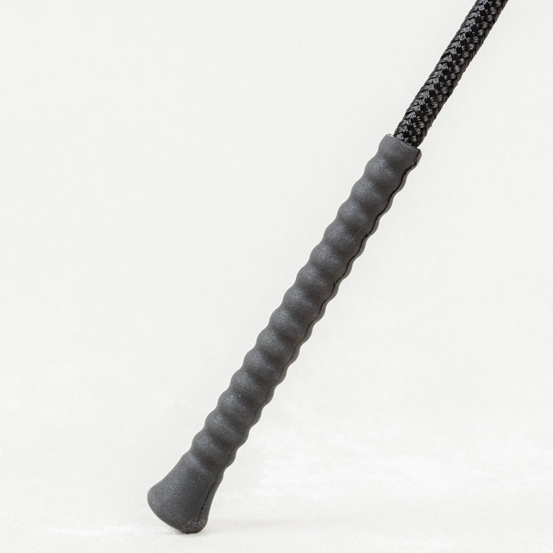 Close-up of Nylon Wrapped Riding Crop with textured grey grip.


