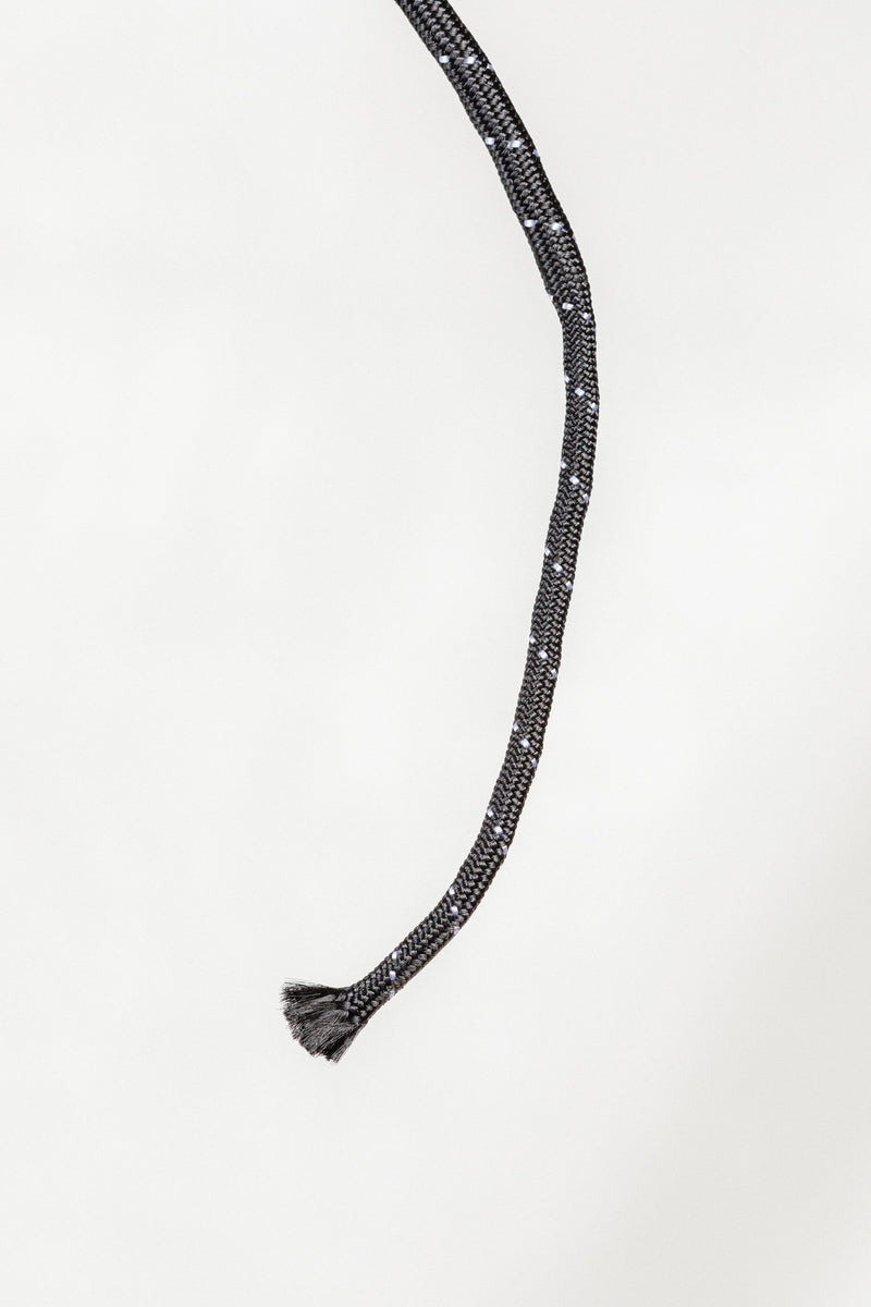 Close-up of Nylon Wrapped Riding Crop showing braided nylon texture and tassel tip.


