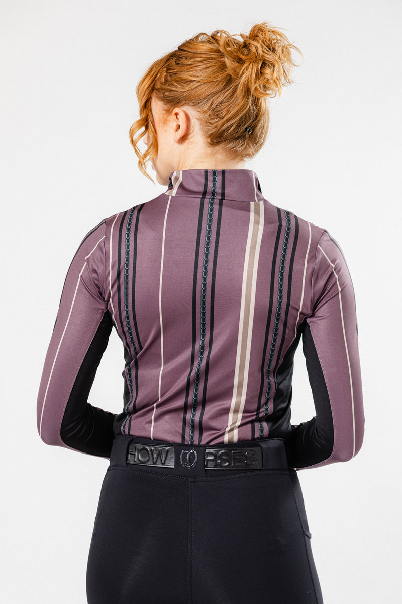 Back view of woman wearing Freedman's Nancy 1/4 Zip Long Sleeve Shirt with striped design, paired with black Jods and a matching Freedman's belt.