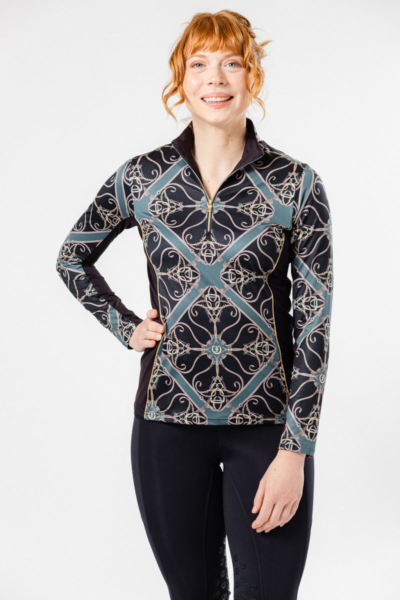 Women wearing the Fantasy 1/4 Zip Long Sleeve Shirt in Black/Forest print. Stylish equestrian-inspired performance top with an intricate geometric pattern, perfect for active and casual wear.