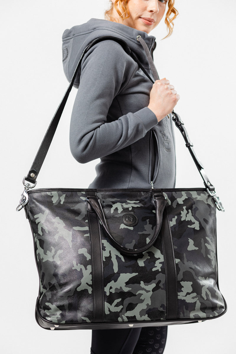 Stylish woman wearing grey hoodie and carrying The Victoria Tote - Large by Freedman's, a black leather tote bag with silver hardware, on her shoulder