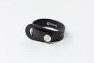 Black leather Signature Leather Bracelet by Freedman's with silver logo button and white stitching, displayed on a white background.