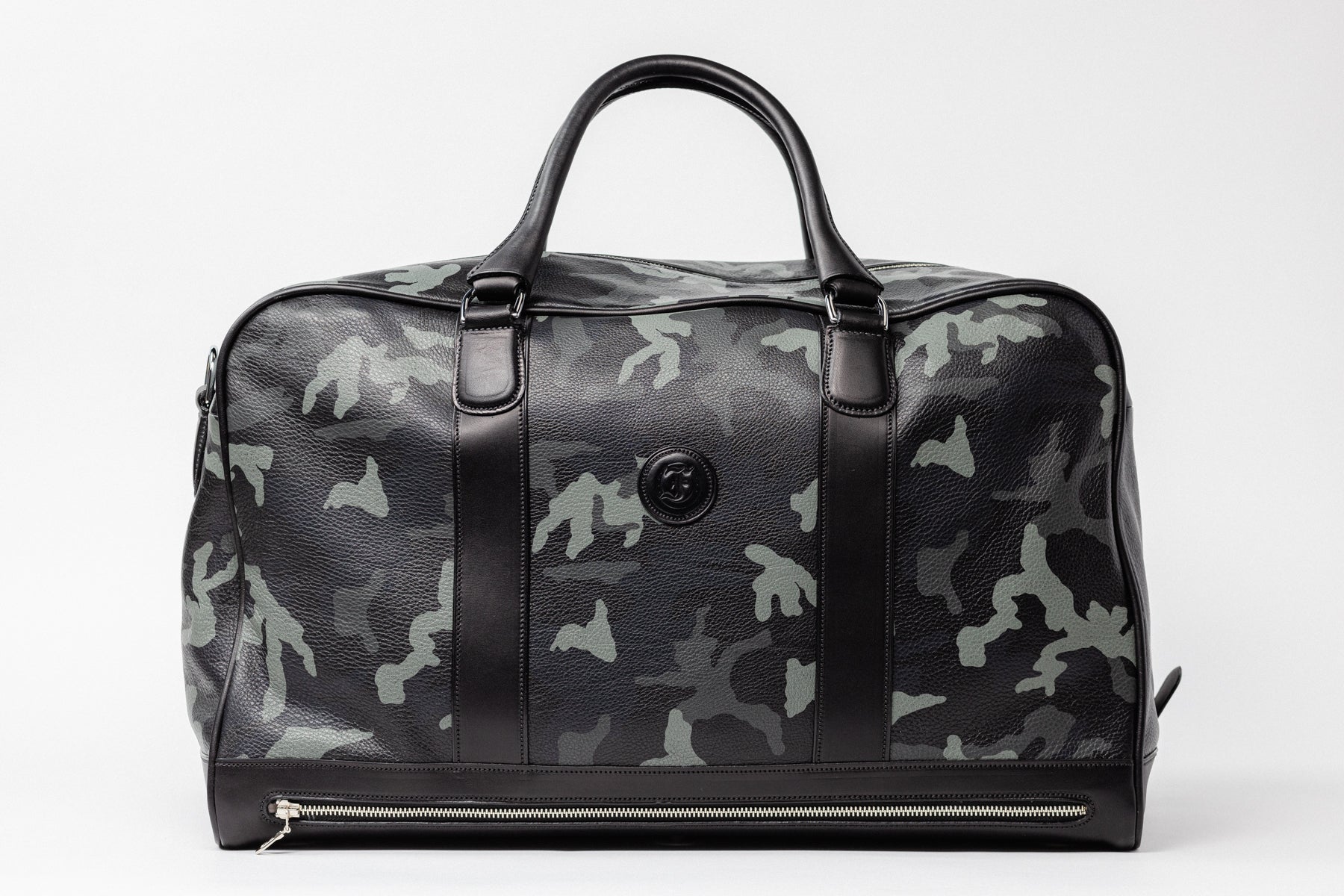 Freedman's Grand Break Duffel Bag, Camo textured leather, silver hardware, embossed logo, patent leather center straps, dual rolled handles, detachable shoulder strap with padded section, zipper closure, white background.